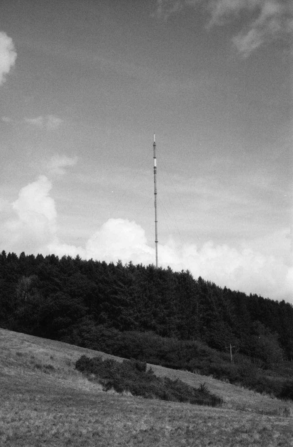 a tall antenna on a hill
