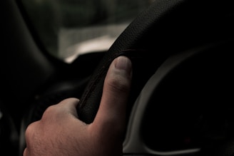 a hand holding a black object