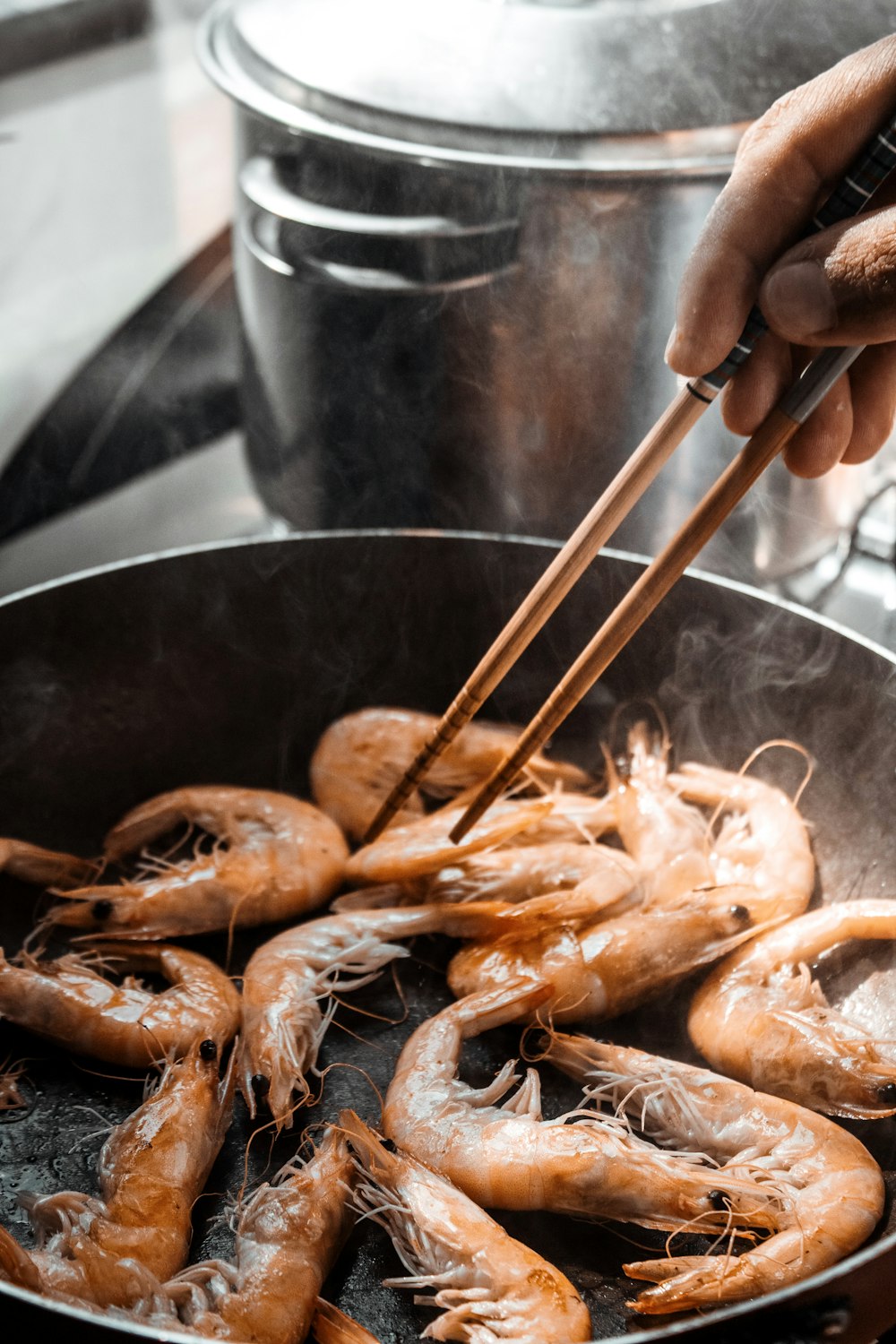 a person cooking food in a pan