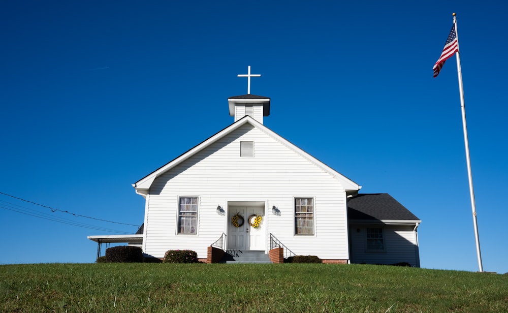 a white church with a flag on top