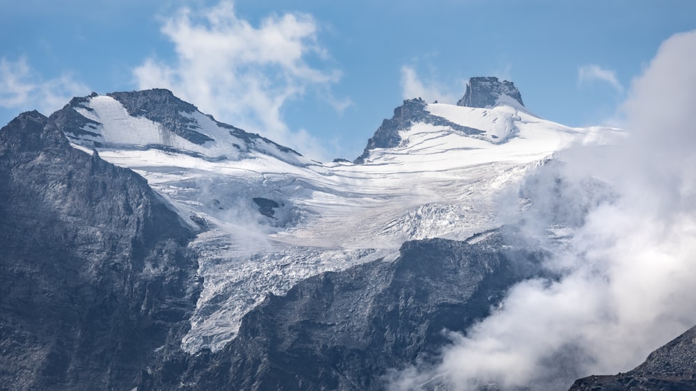 a mountain with clouds below