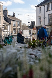 A sunlit photograph of a bustling small town main street from the 1950s, capturing everyday life.