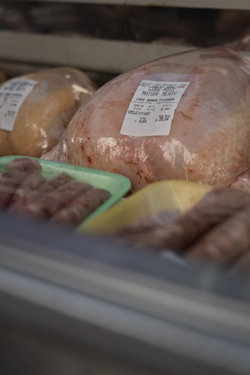 Close-up of fresh whole chickens neatly arranged on ice in a van sale setting.