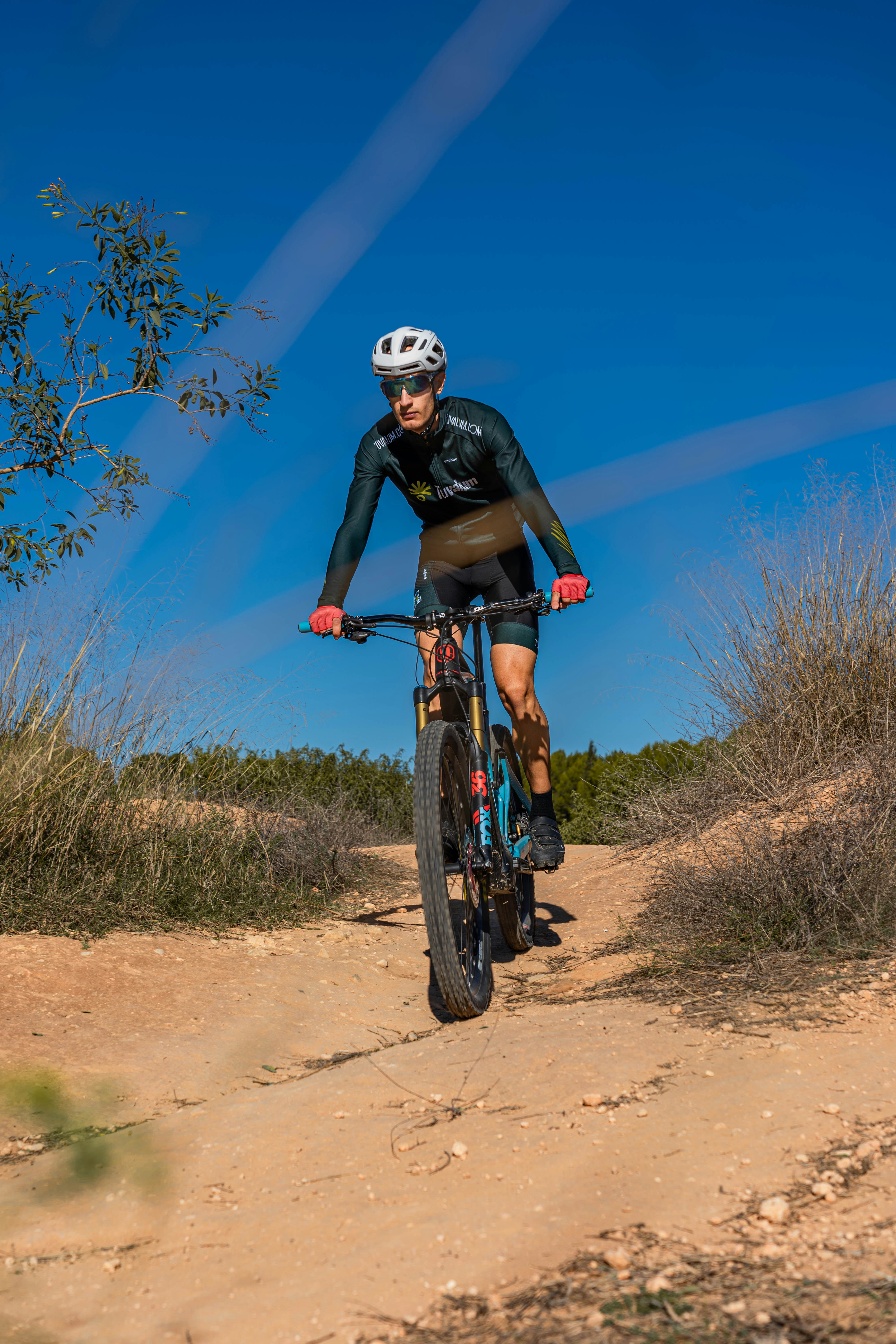 a man riding a bike on a dirt path