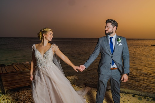 a man and woman walking on a beach