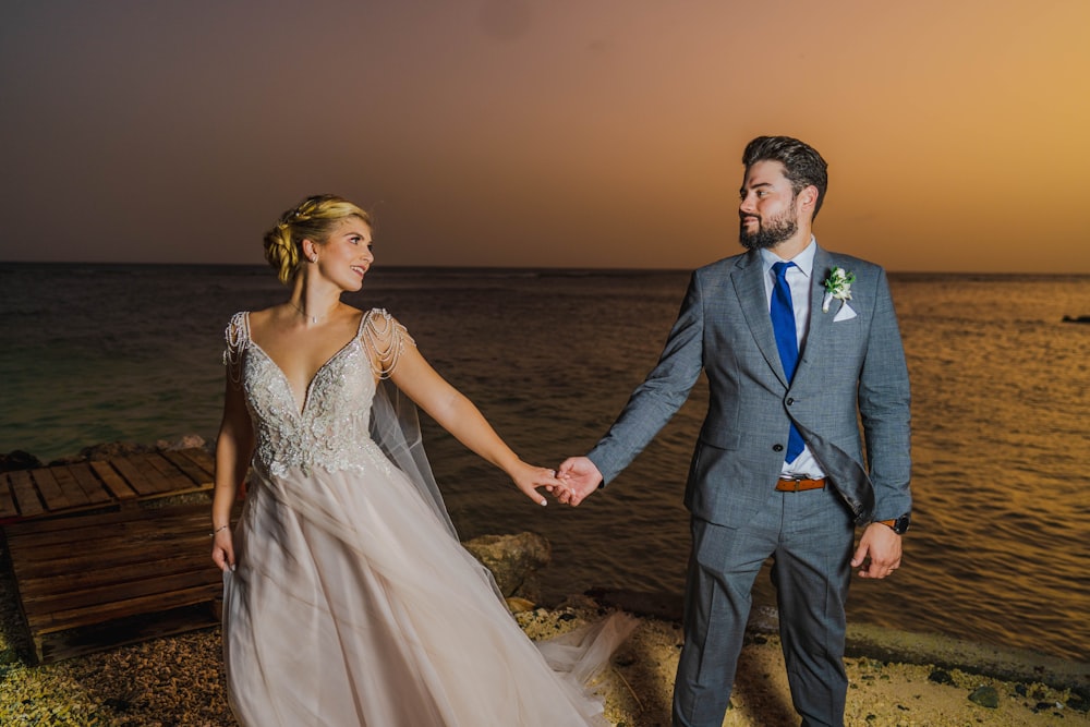 a man and woman walking on a beach