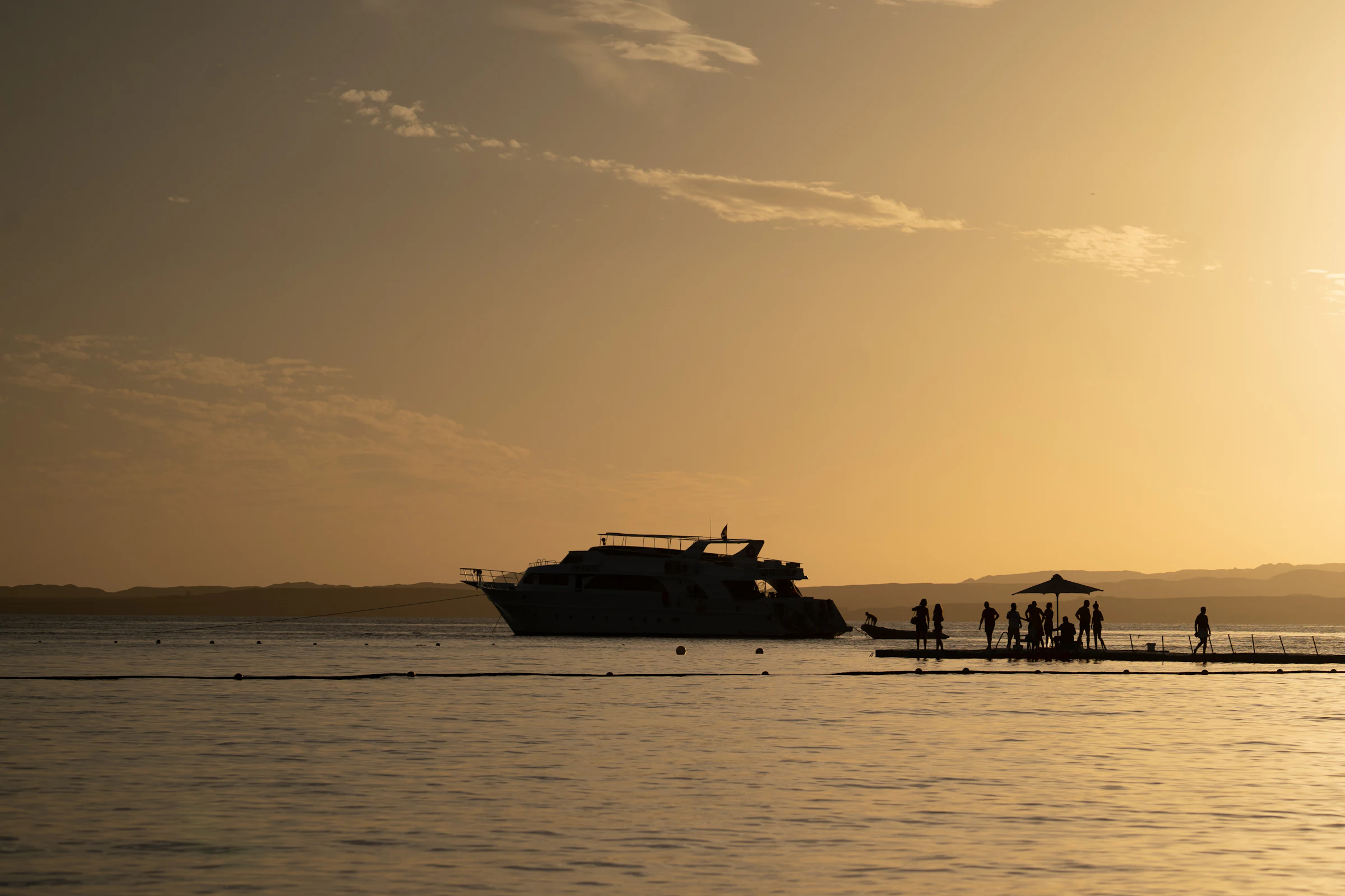 Yacht lit against the water after sundown
