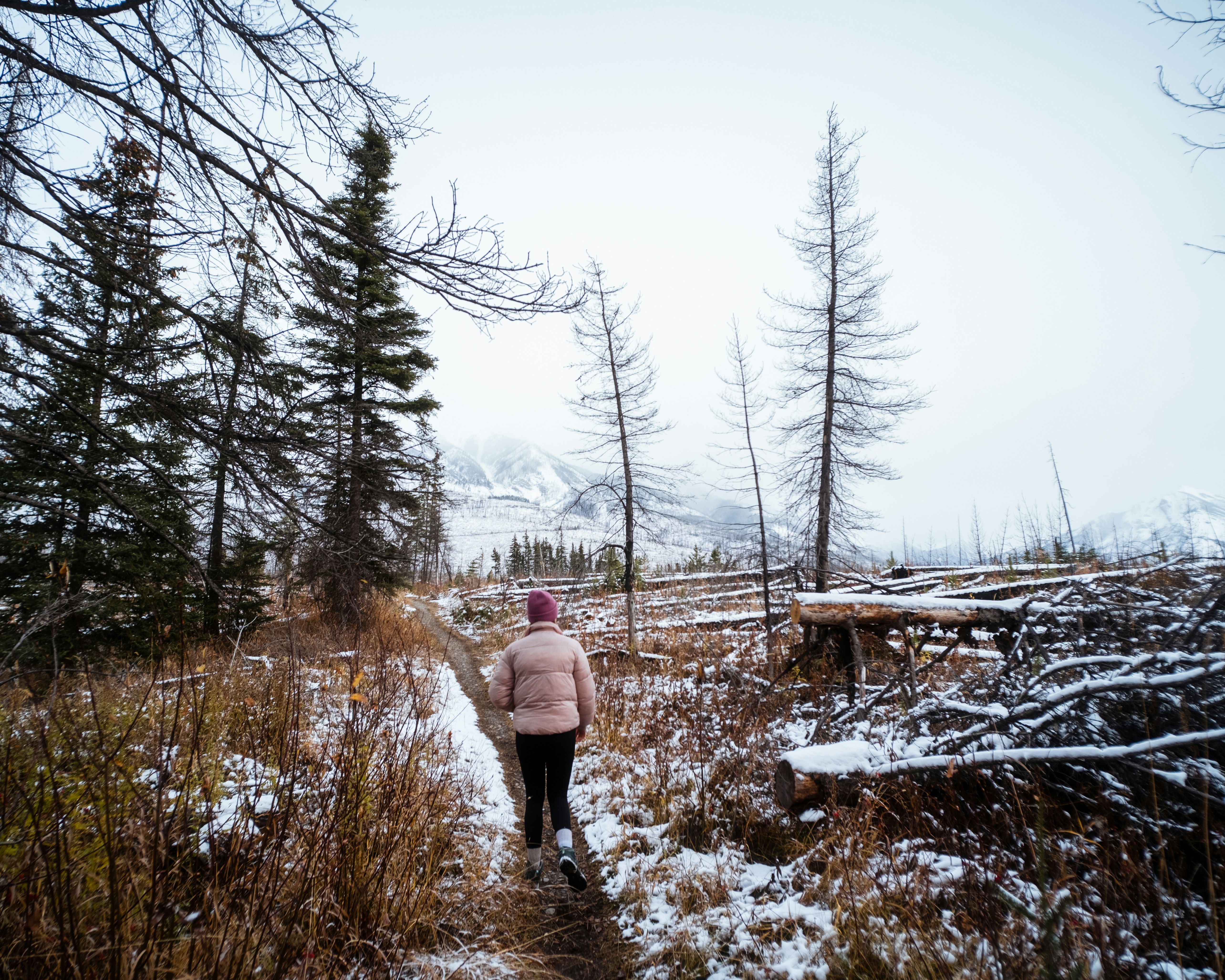 a person walking on a trail in the snow