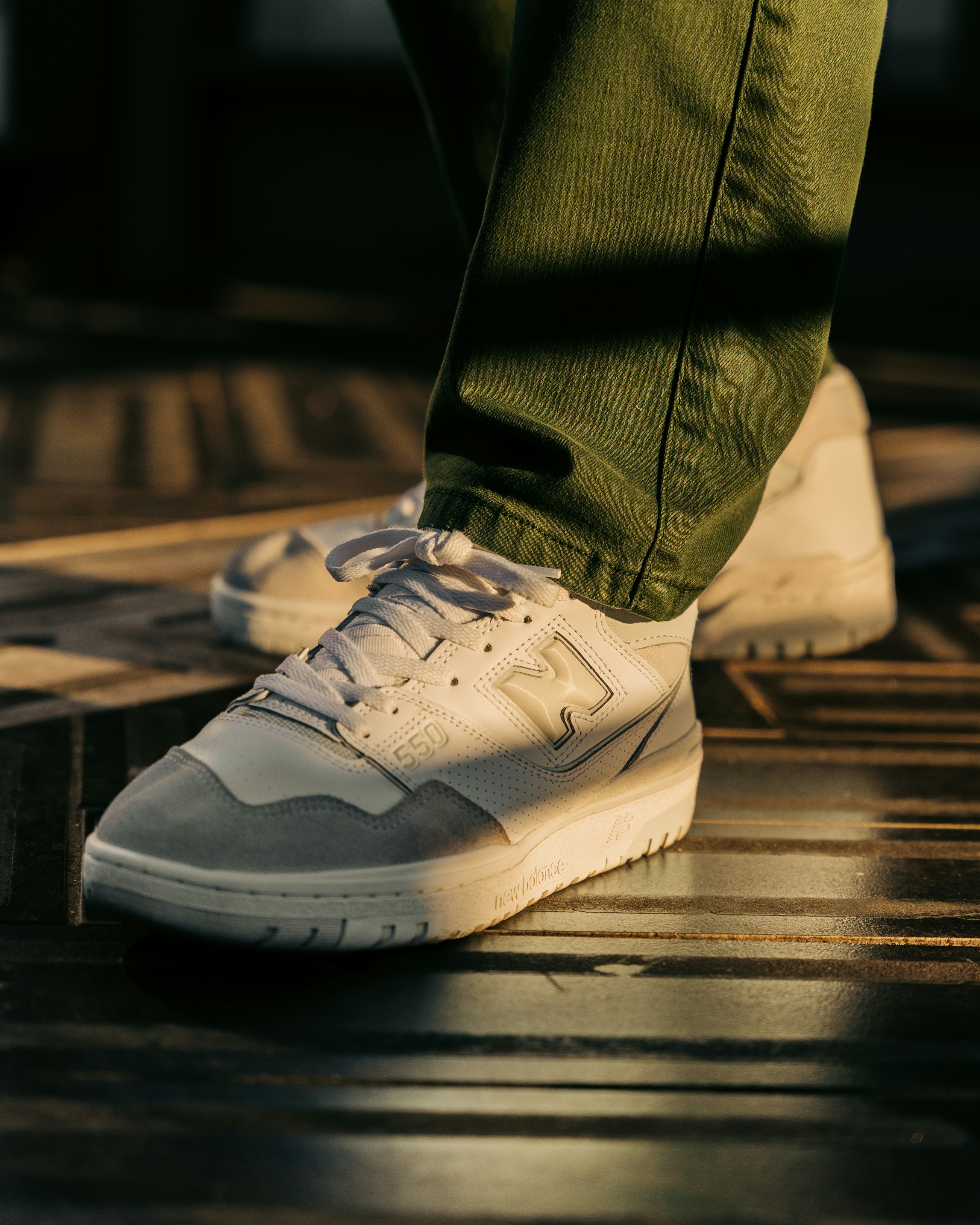 a person's feet in white sneakers