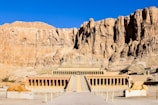 a large building with a mountain in the background