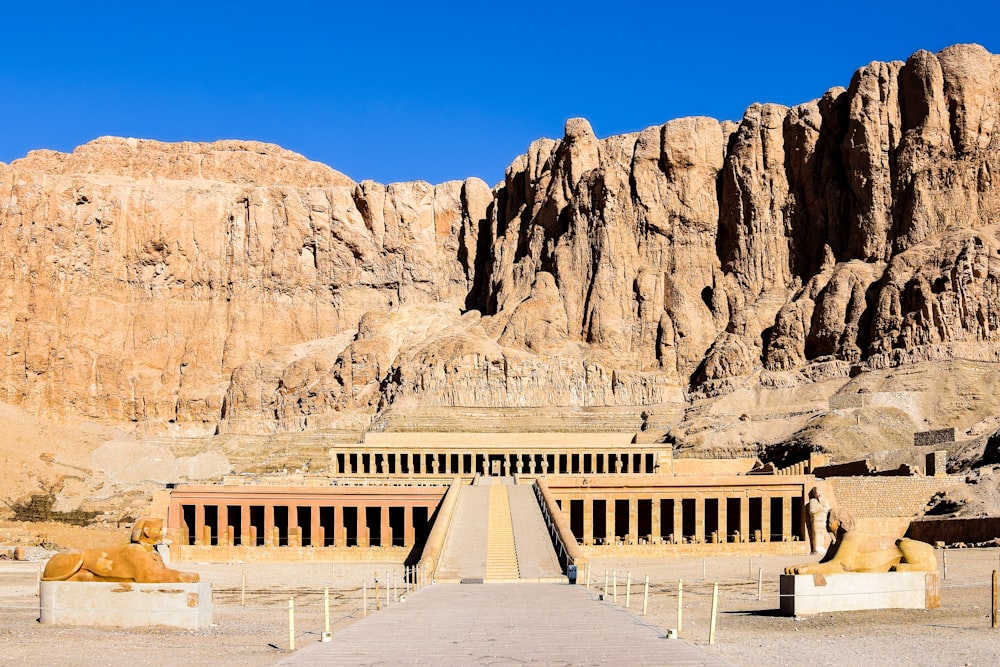 a large building with a mountain in the background