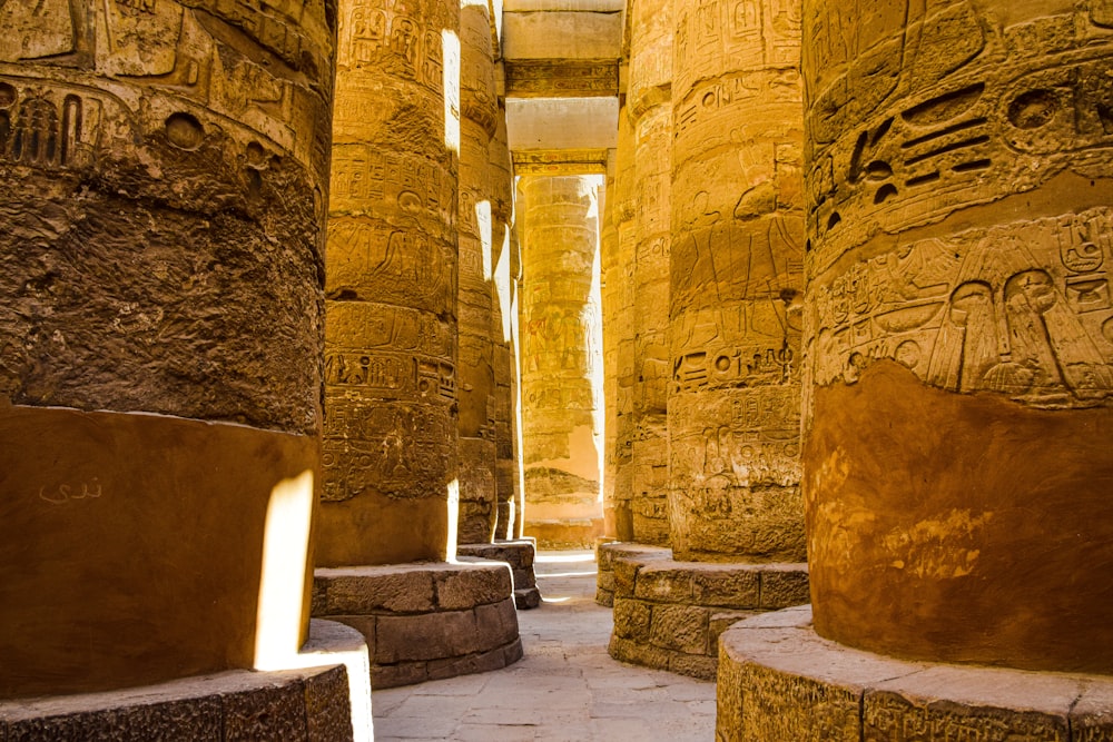a room with stone walls with Karnak in the background