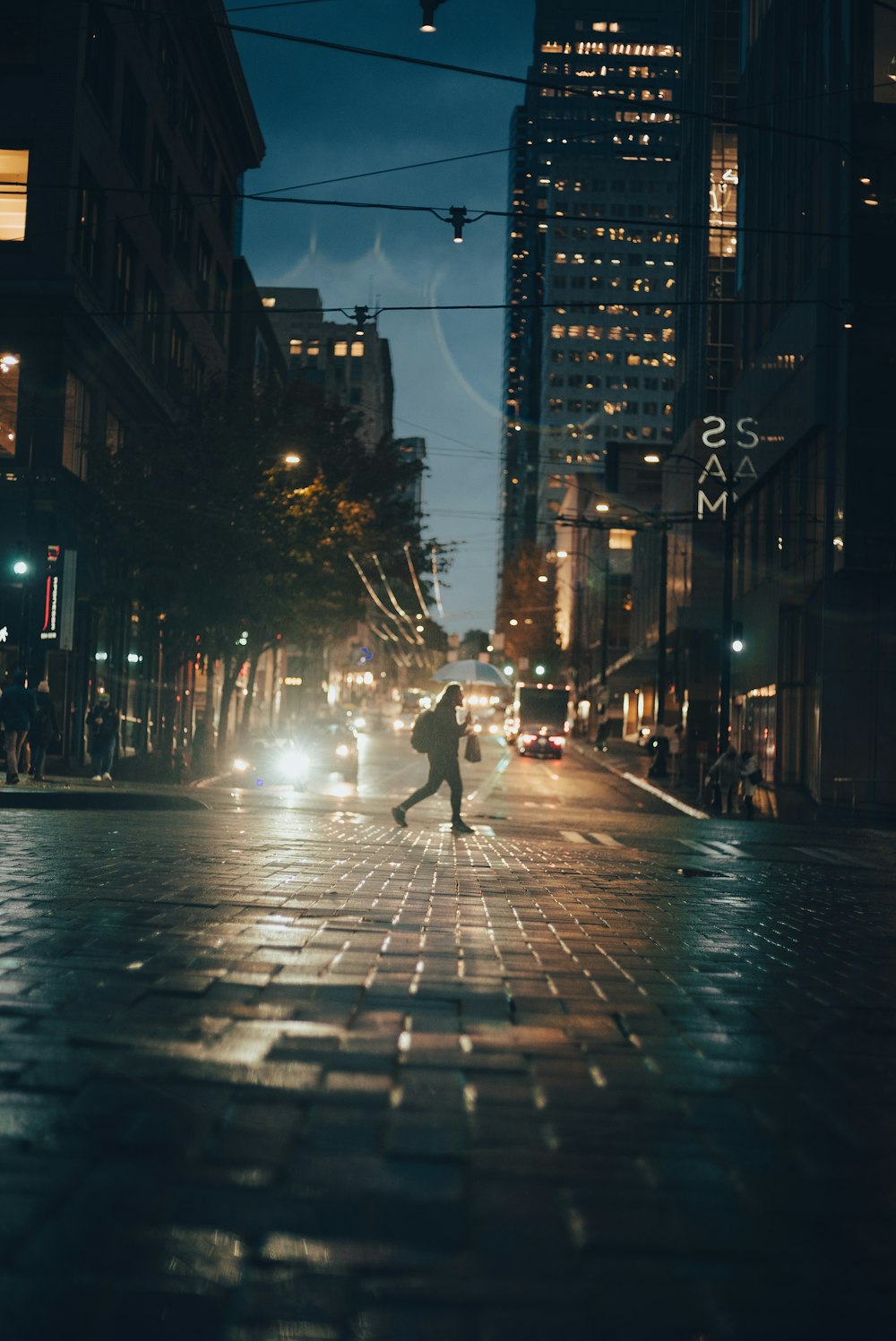 a person walking down a wet street