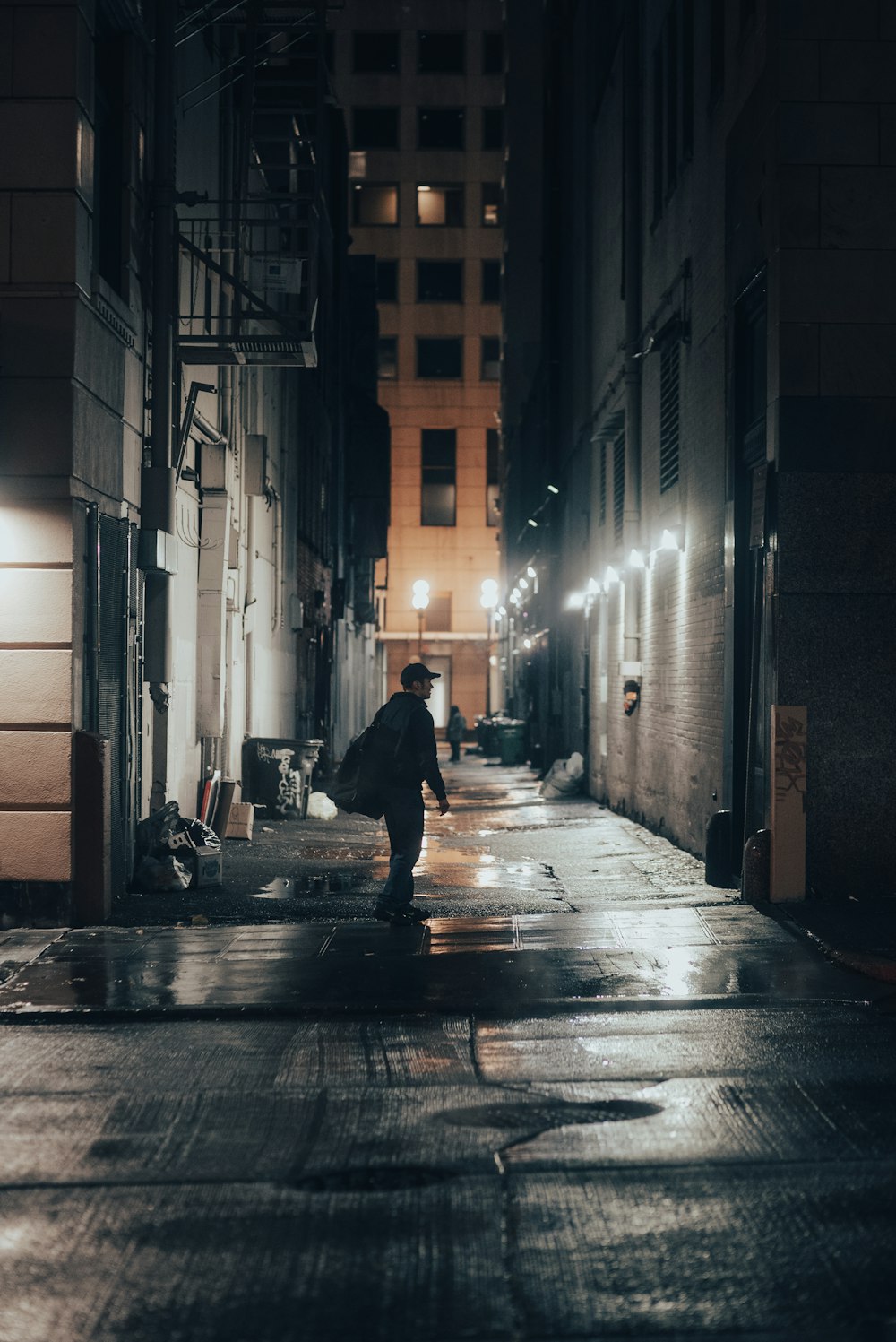 a person walking in a street at night