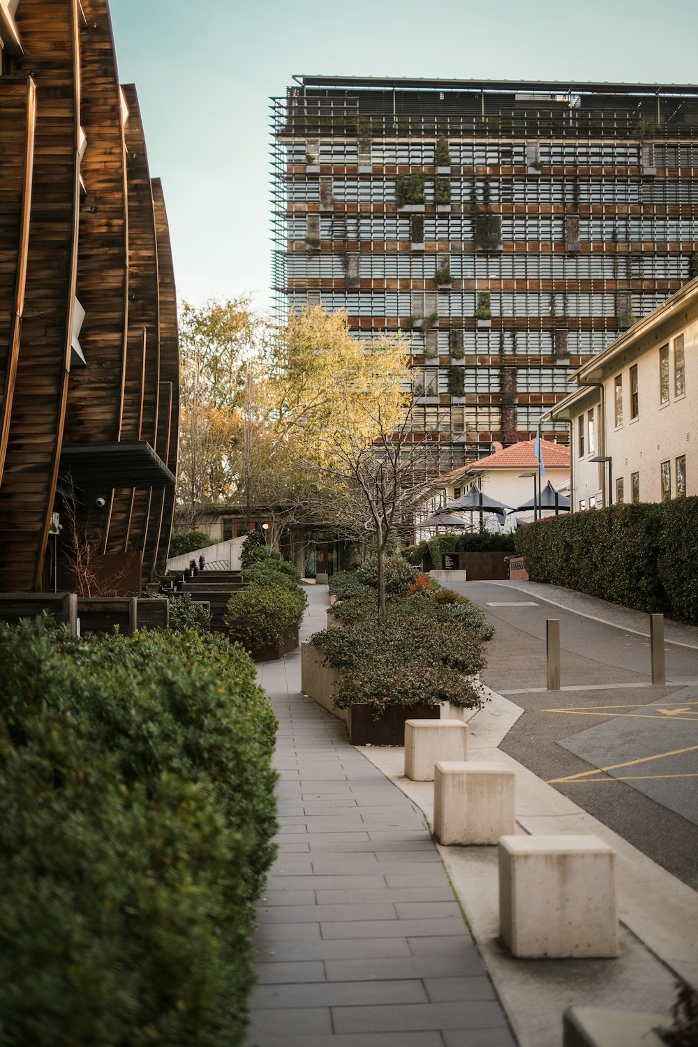 a building with a walkway and trees