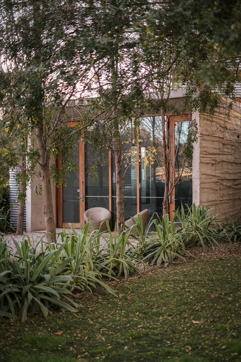 a building with trees and plants around it