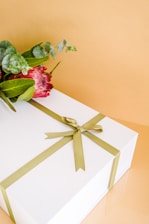 a rose on a white shelf