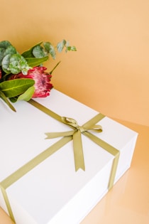 a rose on a white shelf