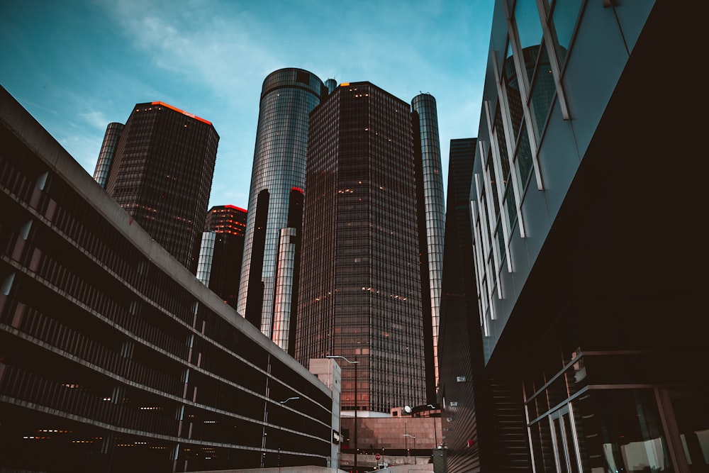 a group of tall buildings with Renaissance Center in the background