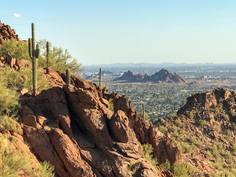 a rocky hillside with a city in the distance