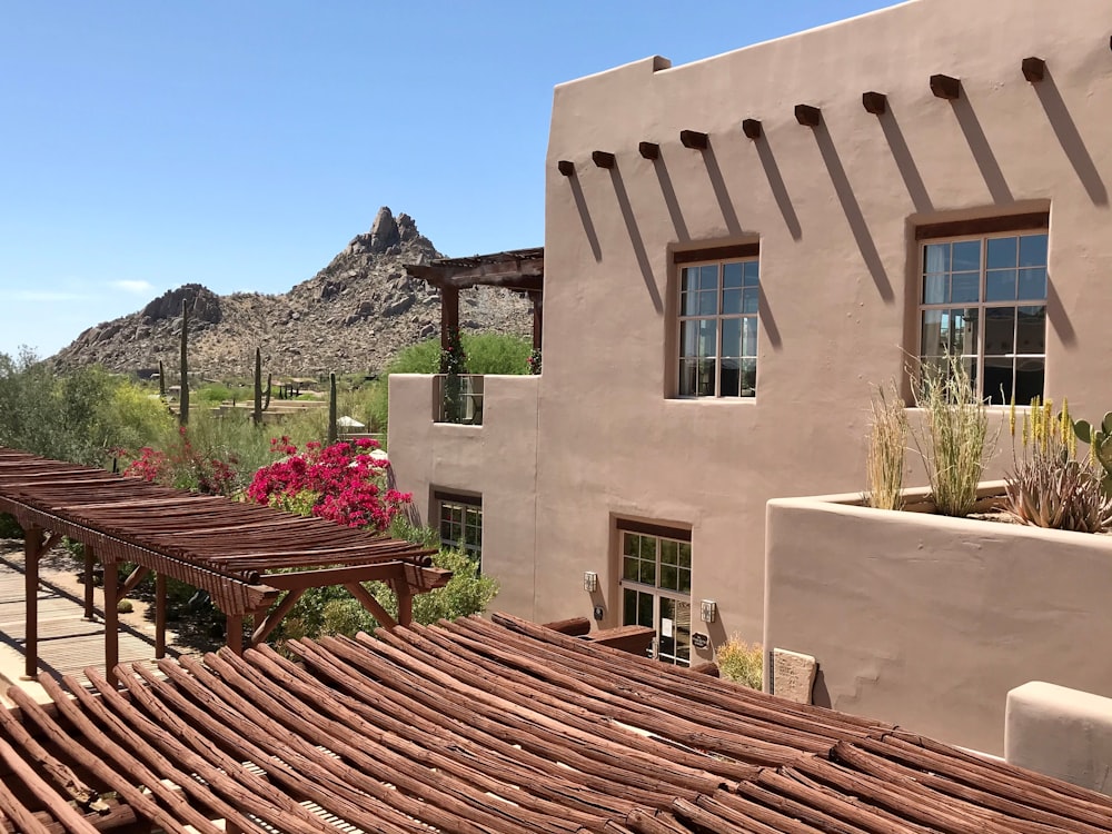 a house with a deck and a mountain in the background