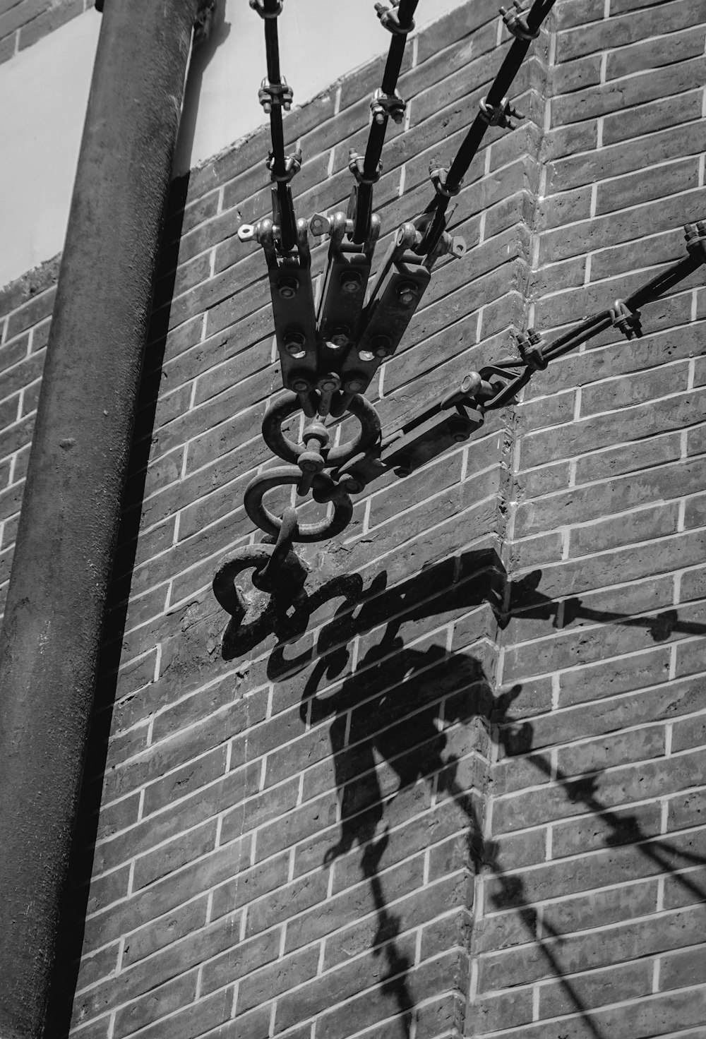 a metal cross on a brick wall