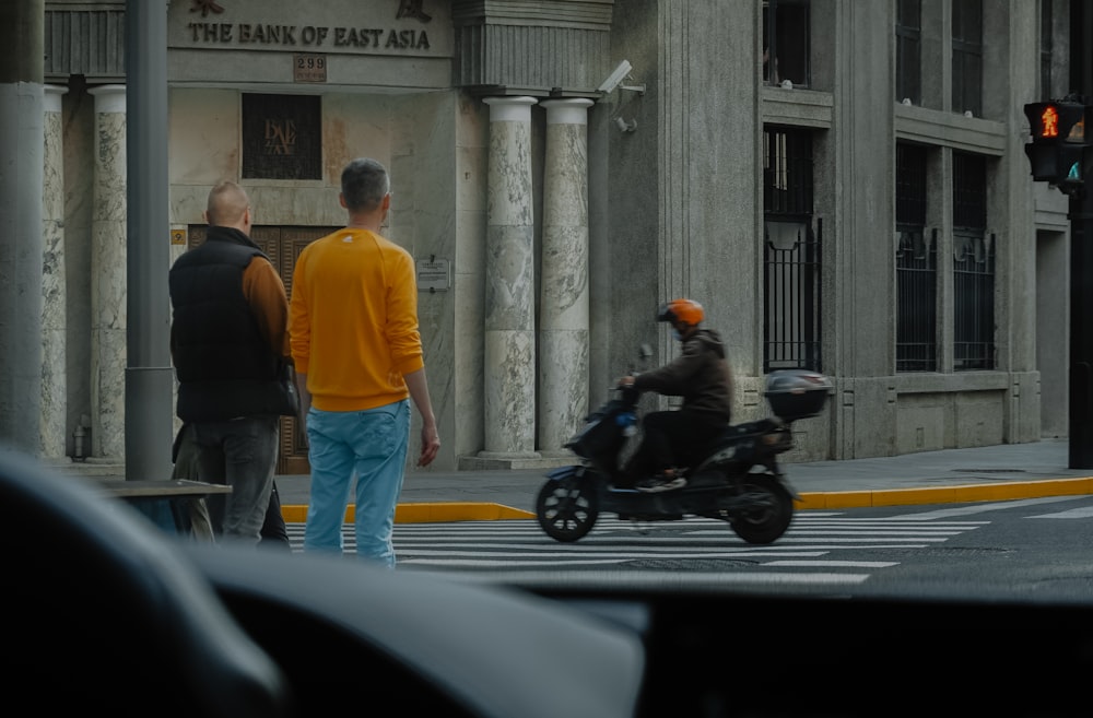 a person riding a motorcycle down the street