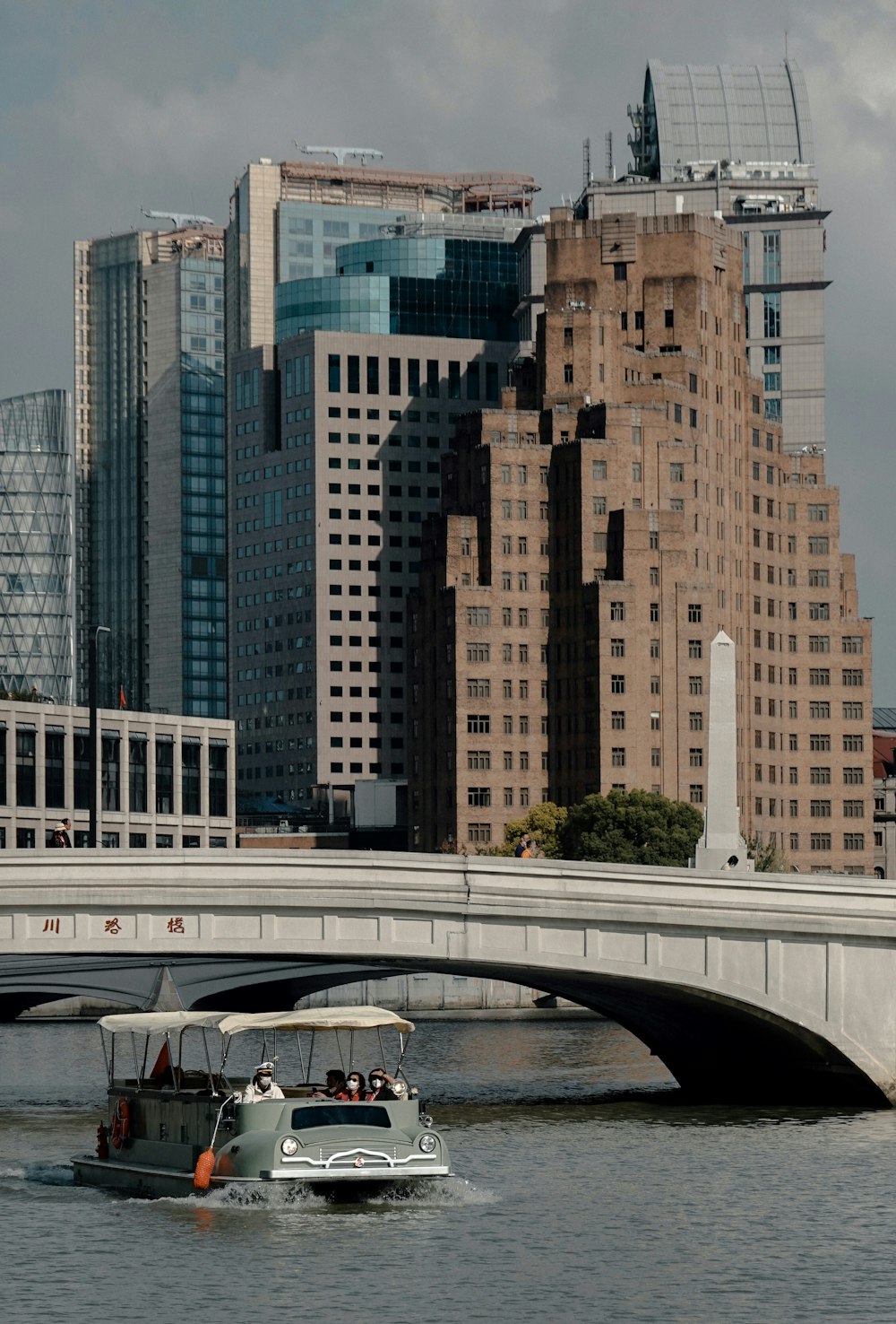 a boat on a river in front of a city