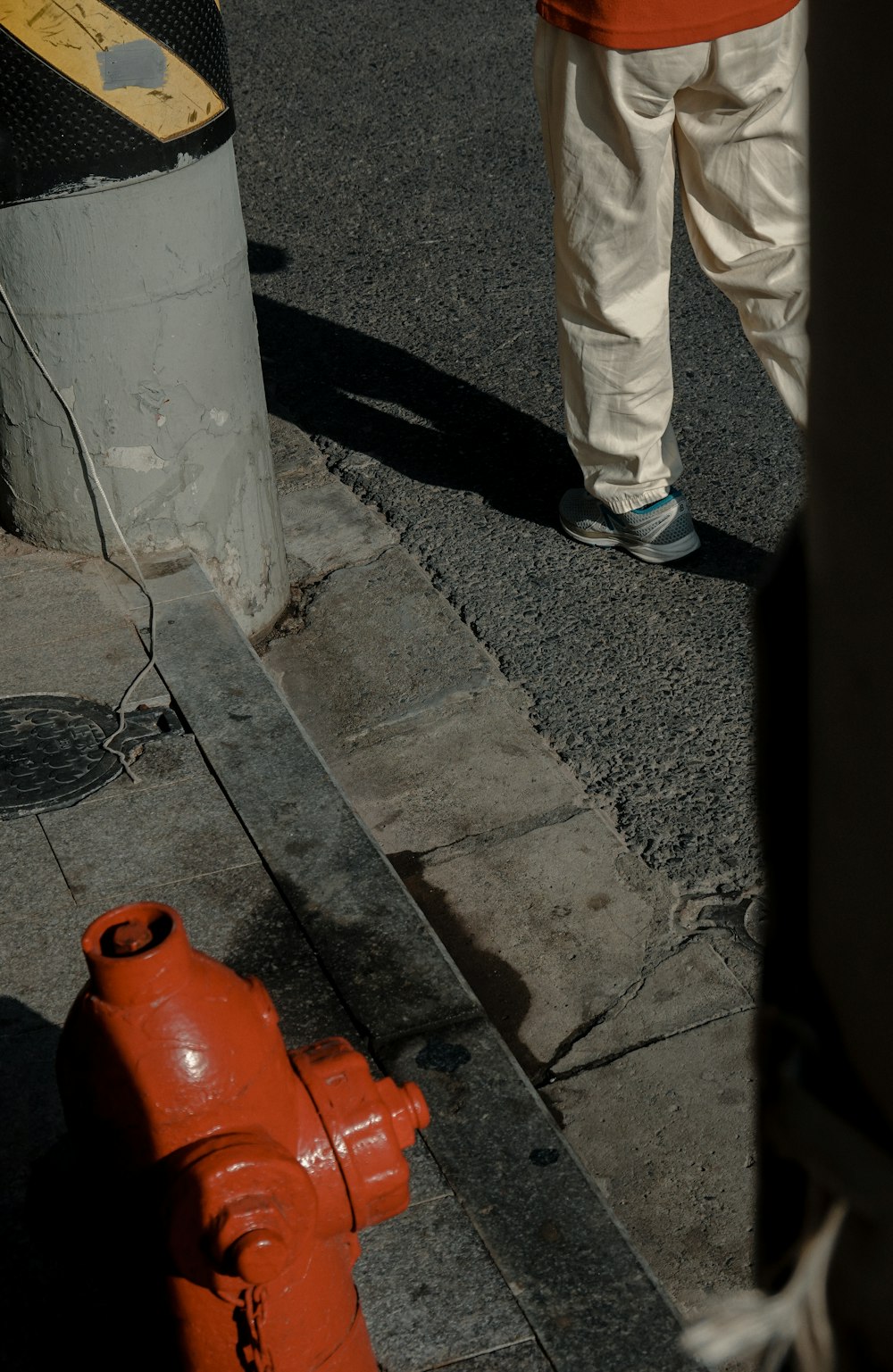 a person stands next to a fire hydrant