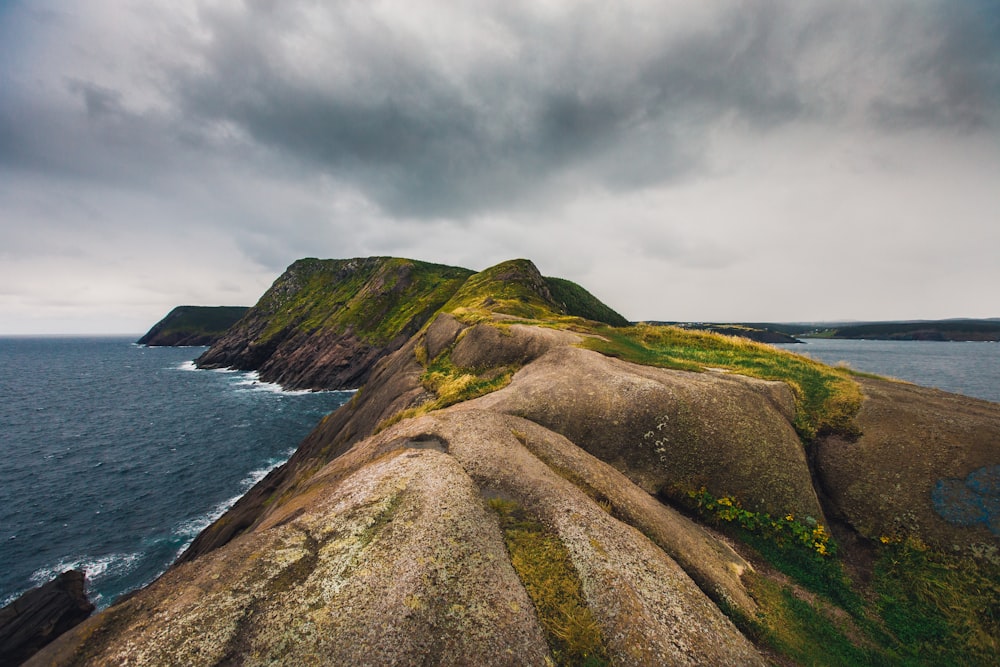 a rocky cliff next to the ocean