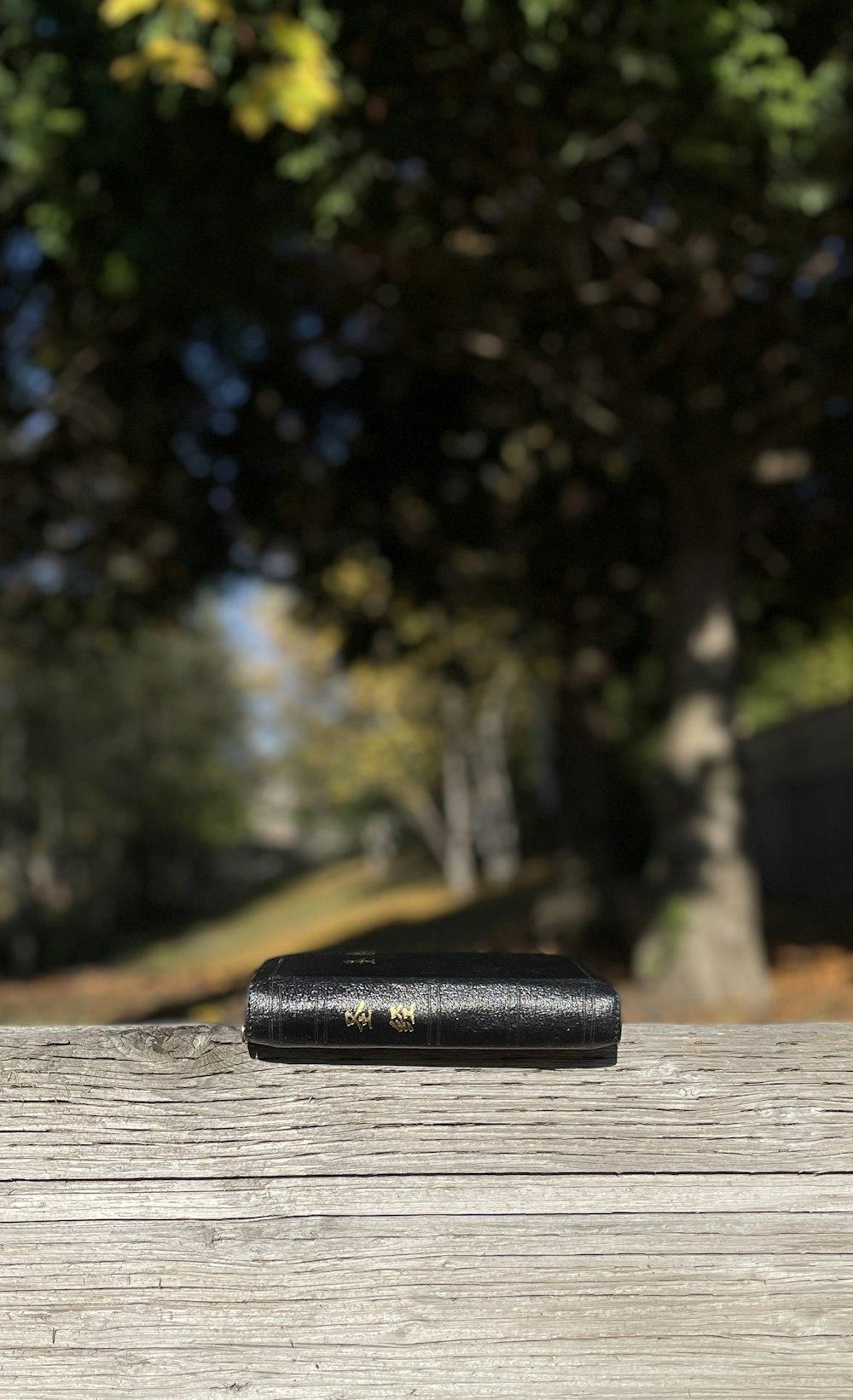 a black lighter on a wooden surface