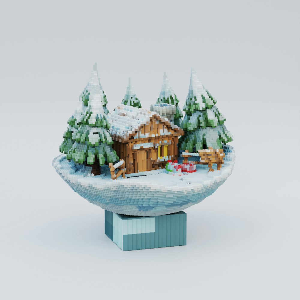 a toy house on a snowy hill