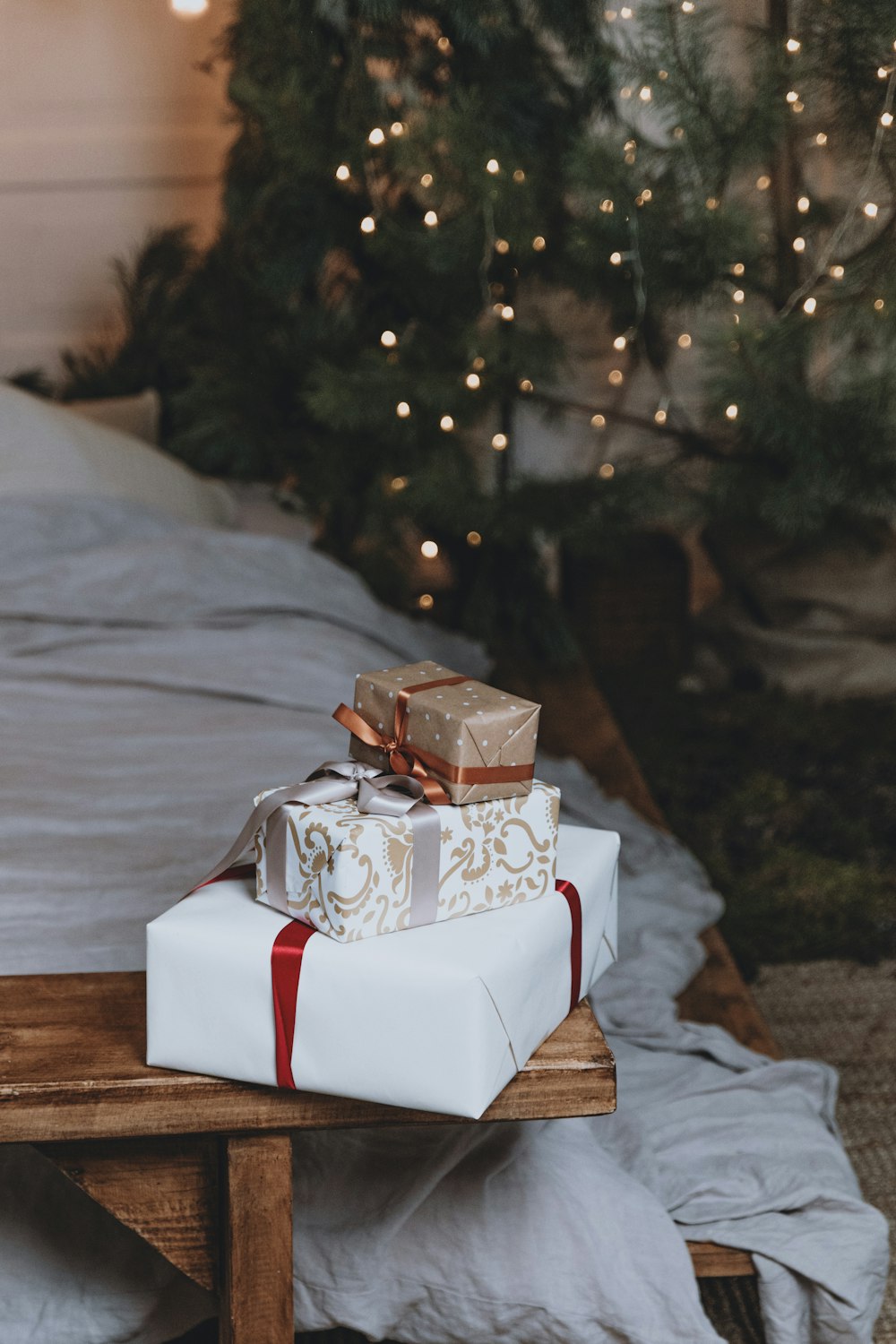 a white box on a table in front of a christmas tree