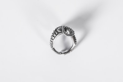 Close-up of a silver ring with intricate design.