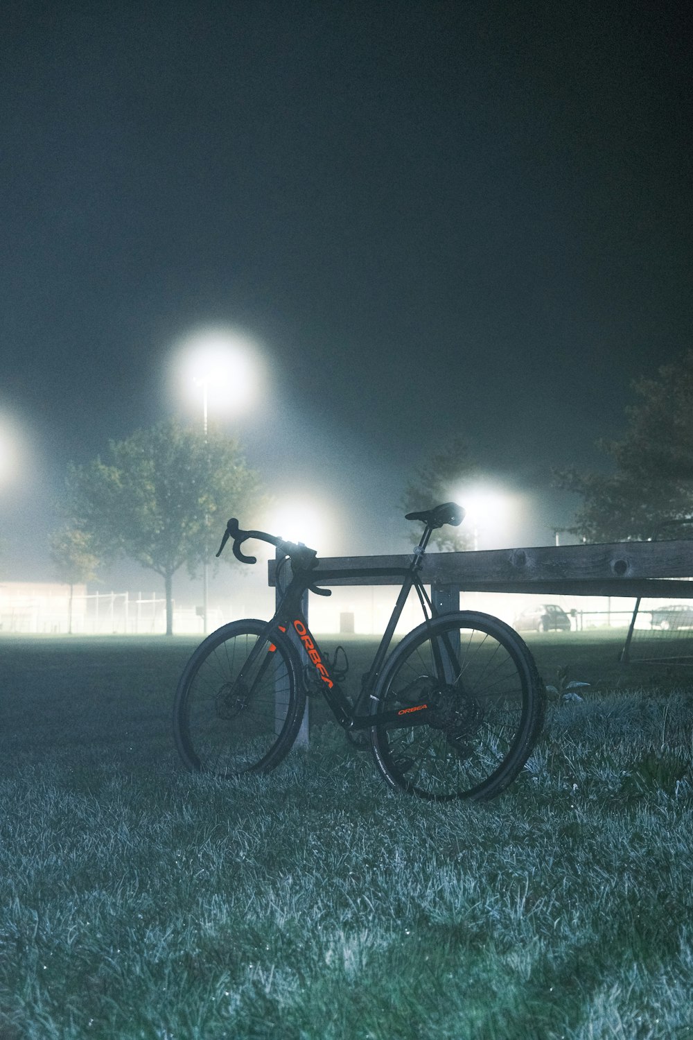 a bicycle parked on a fence