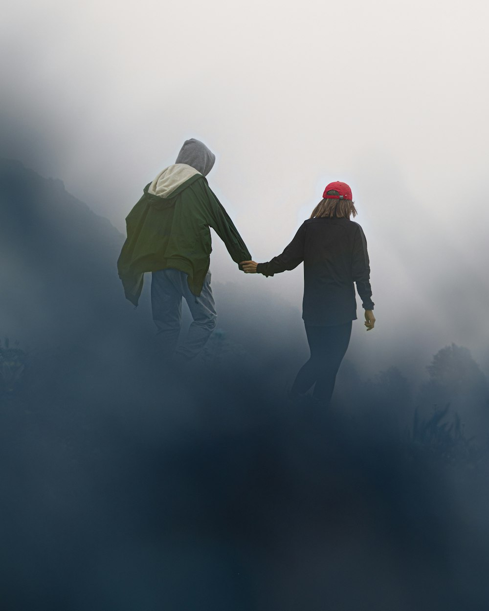 a man and woman walking in the fog