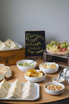 Beautifully arranged catering spread featuring Ecuadorian specialties on wooden platters.