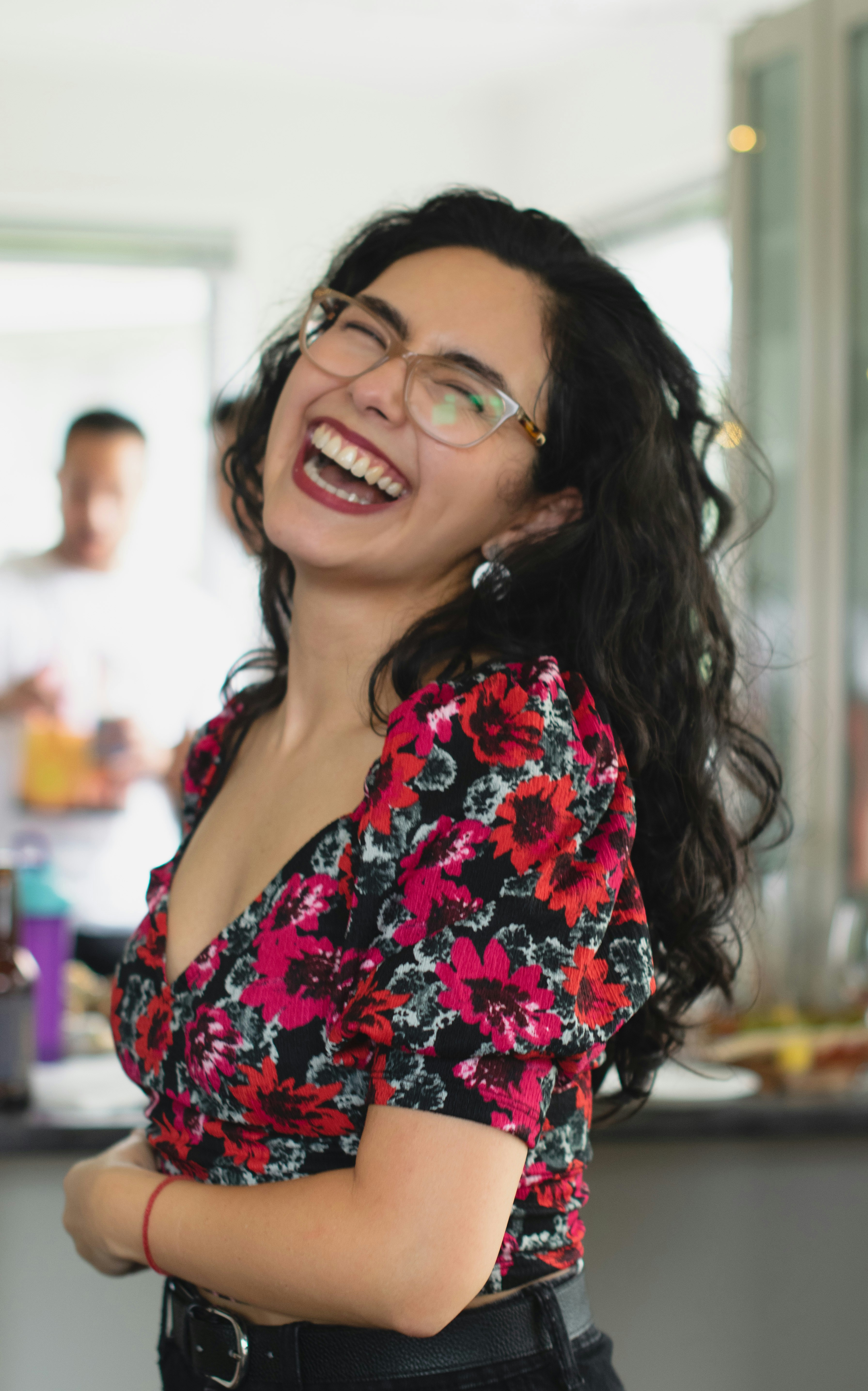 a woman with glasses smiling