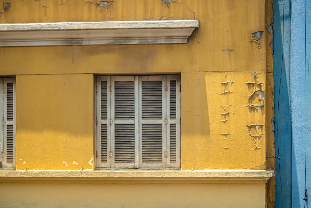 a yellow building with windows