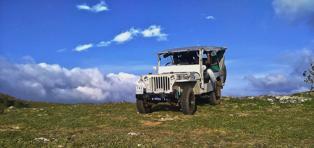 a jeep parked on a grassy hill