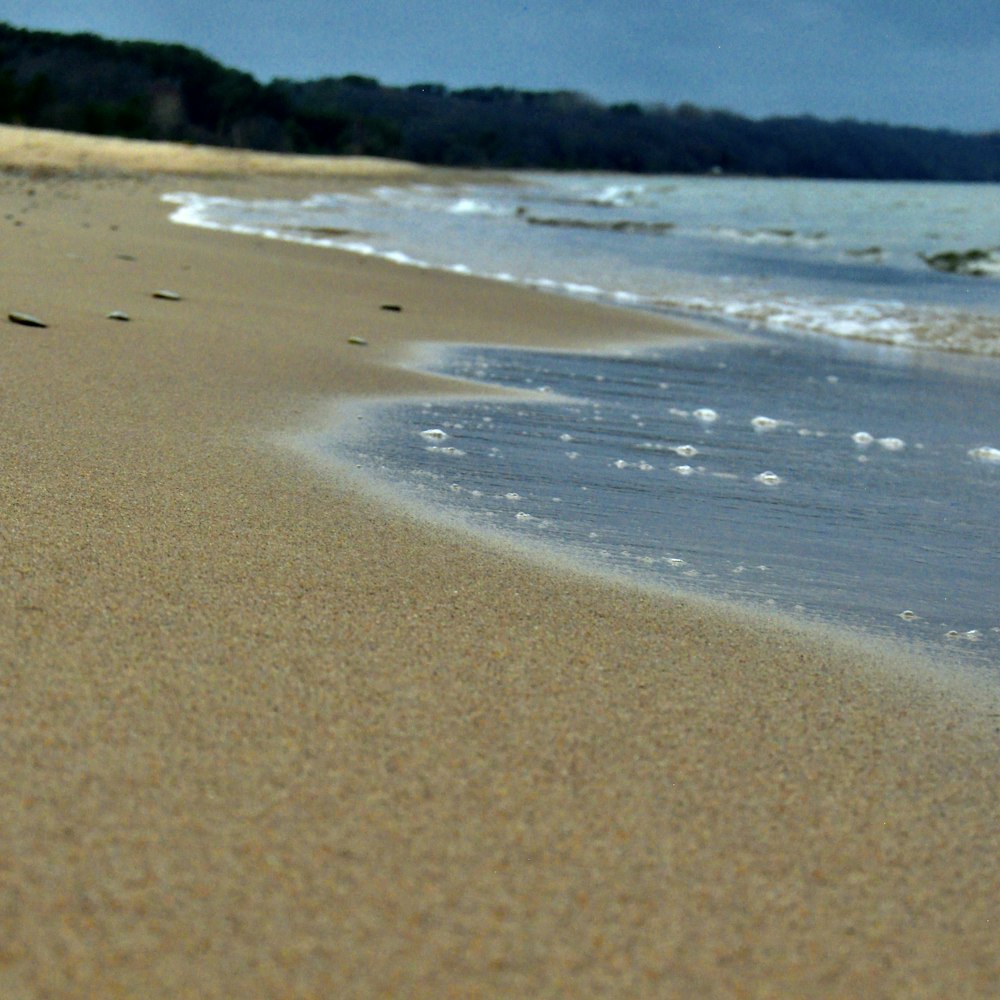 a beach with waves crashing on it