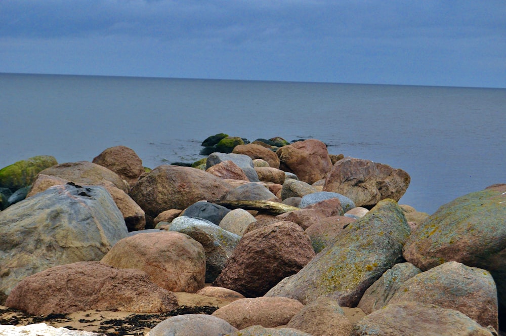 a group of rocks by the water