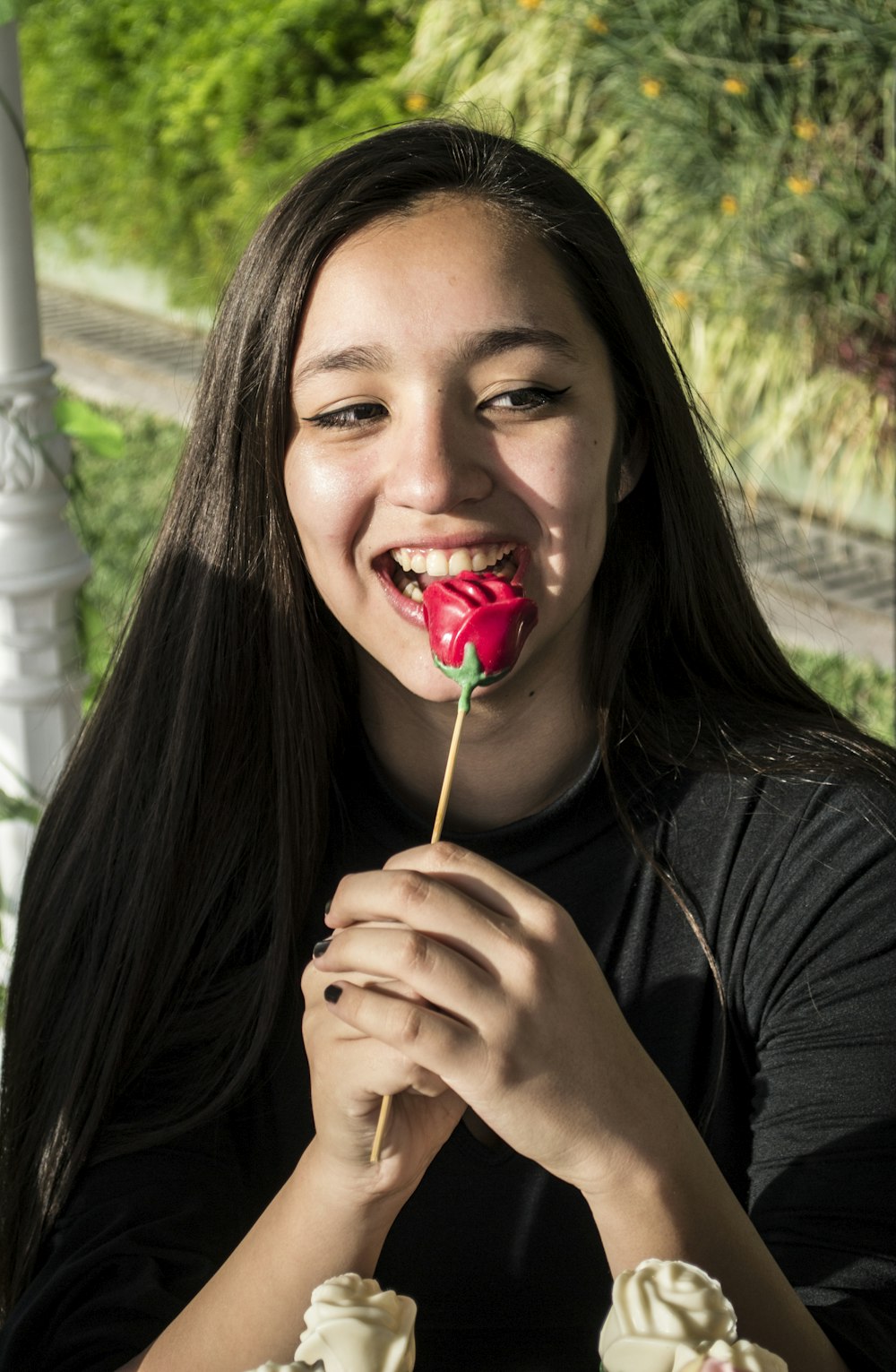 a woman eating a strawberry