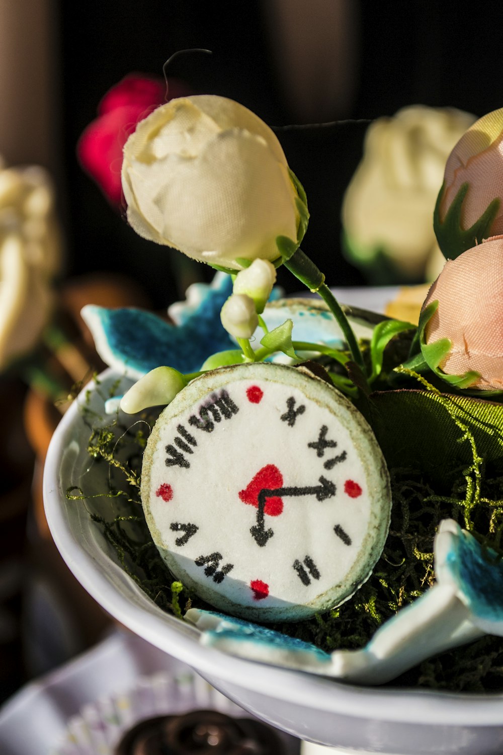 a clock with flowers on top