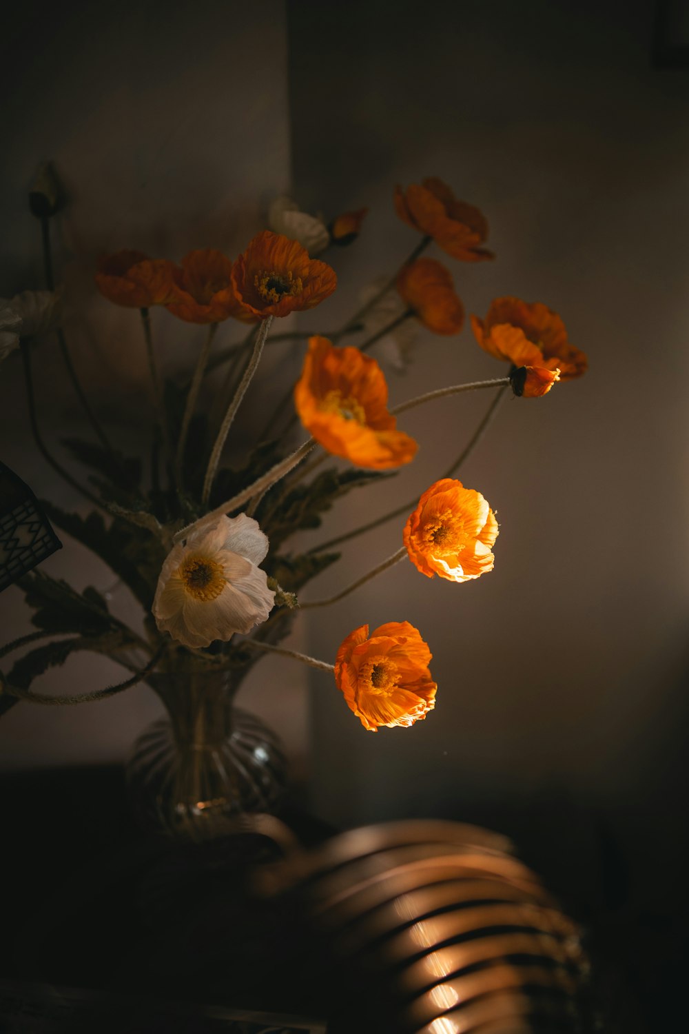 a vase with orange flowers