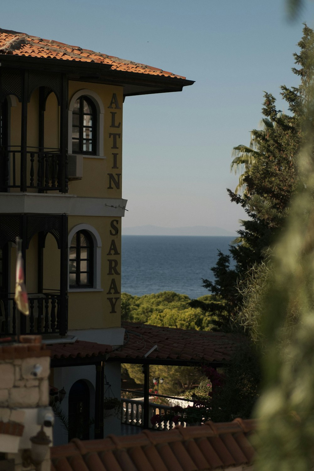 a building with a body of water in the background