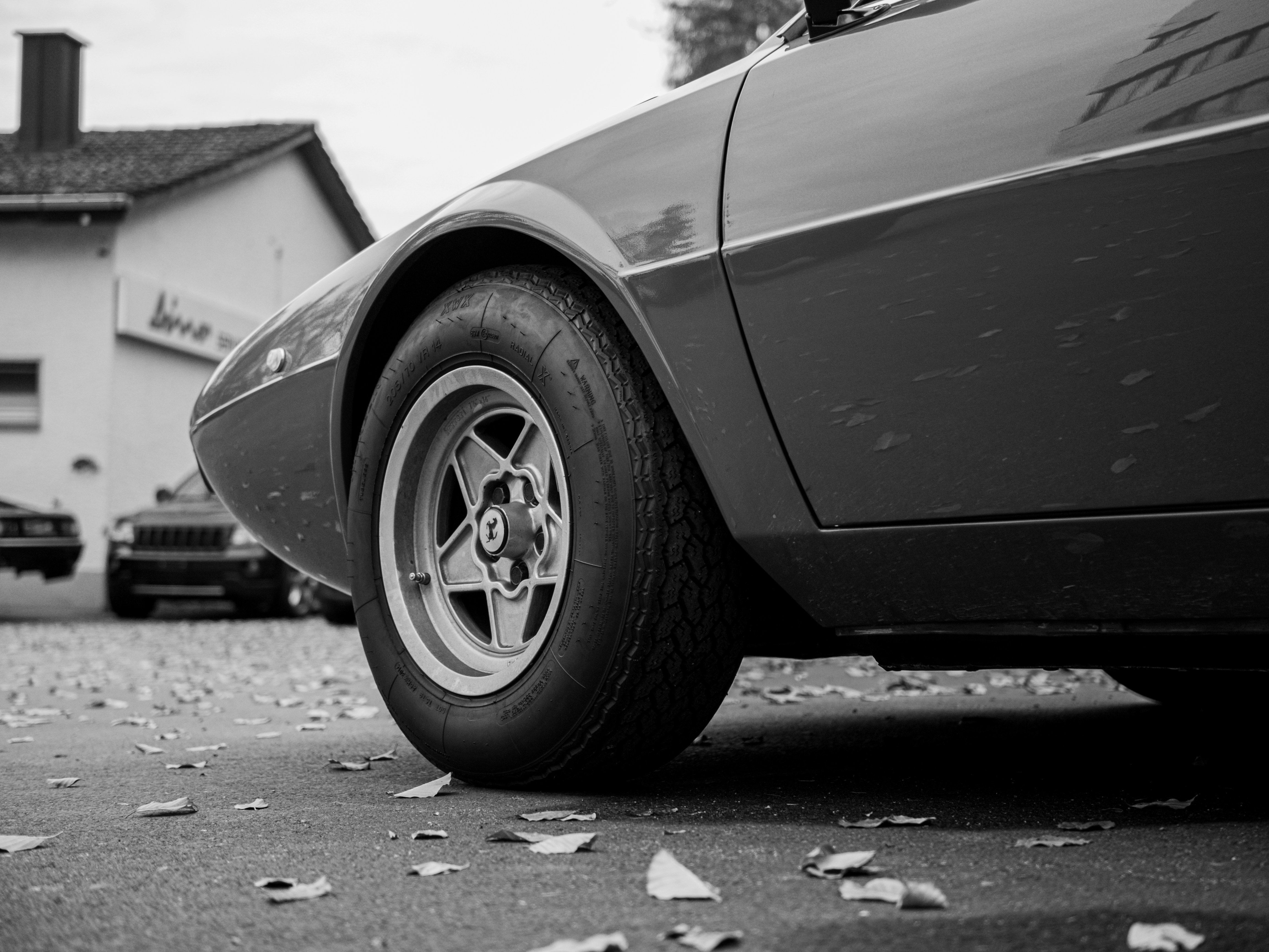 A car with a flat tire photo Free Reidholz garage ag Image on Unsplash