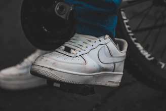 Close-up of a sneaker protected by a Ride Solex gear shift cover on a motorcycle pedal.