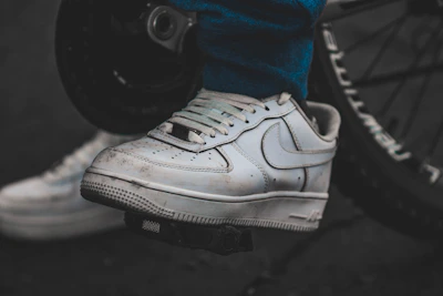 Close-up of a sneaker protected by a Ride Solex gear shift cover on a motorcycle pedal.