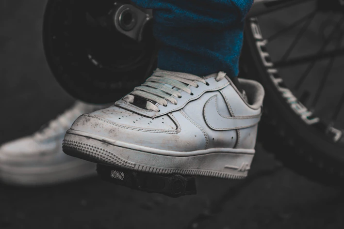 Close-up of a sleek sneaker protector fitted on a bike gear lever, highlighting its durable material.